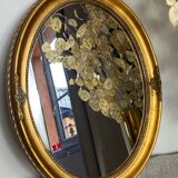Oval-shaped gilded wooden mirror
