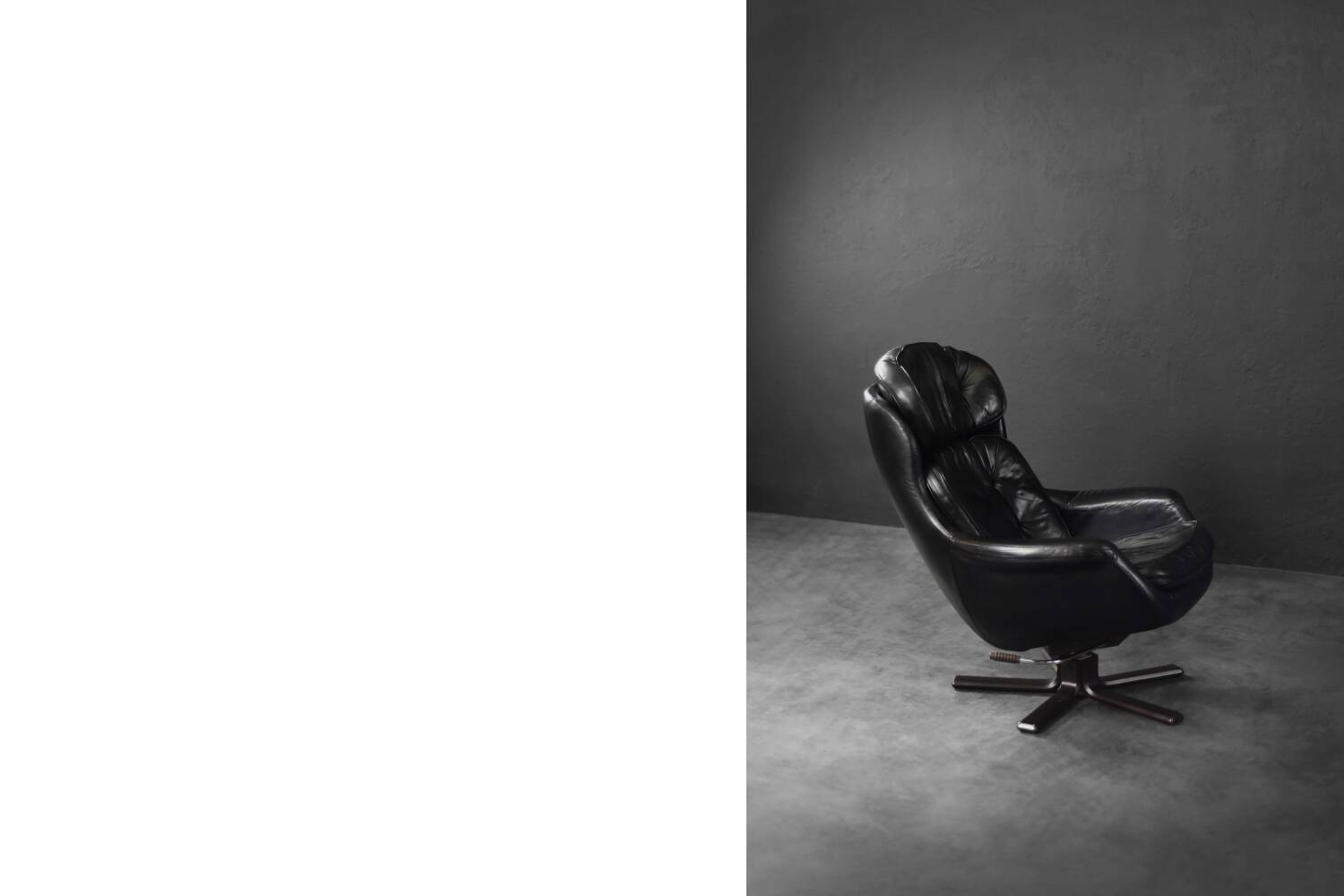 Vintage black leather swivel chair in mid-century modern Scandinavian style.