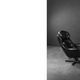 Vintage black leather swivel chair in mid-century modern Scandinavian style.