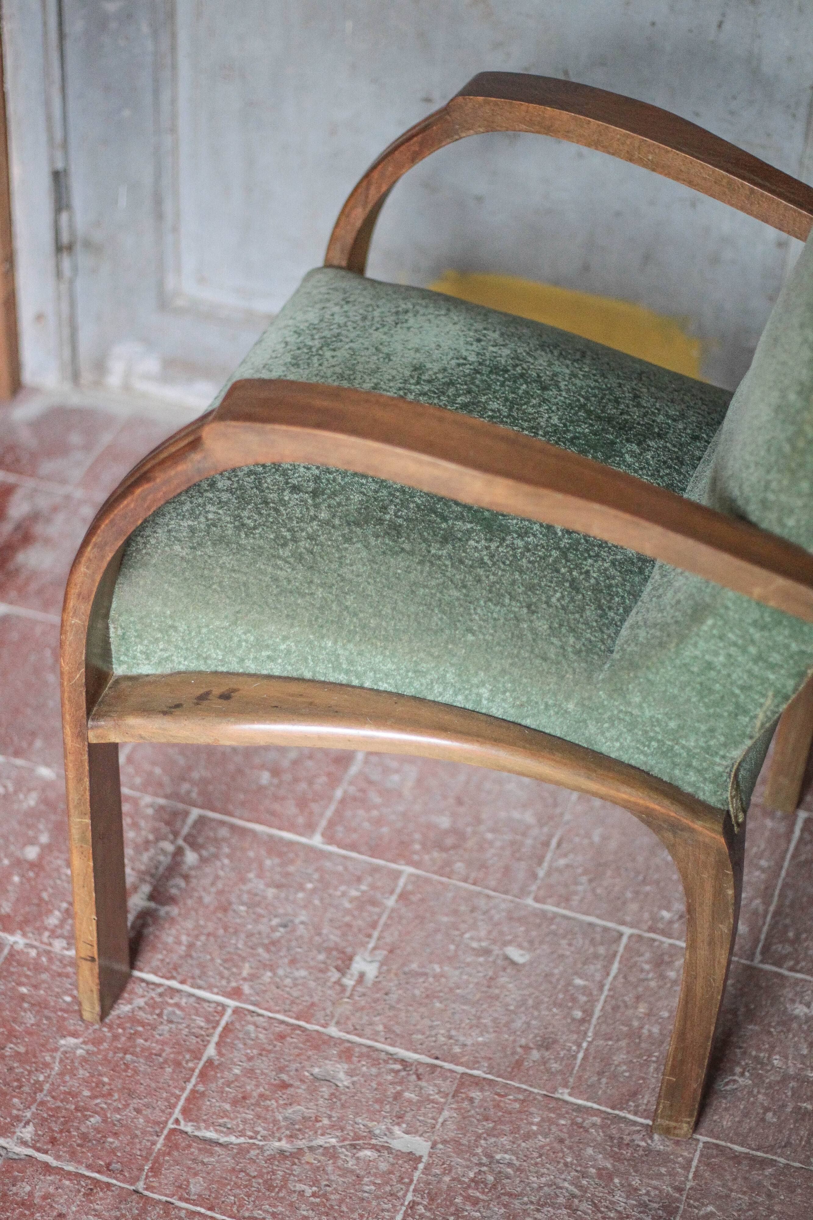 Art Deco armchair in wood and green fabric, living room armchair, interior decor.