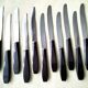Box of 12 vintage table knives in stainless steel and brown bakelite
