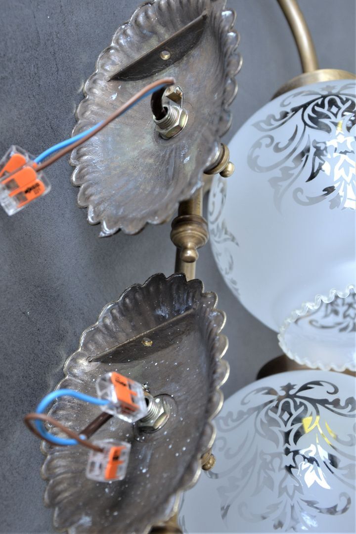 Pair of engraved glass wall lamps, brass support