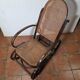 Curved wooden rocking chair with caning