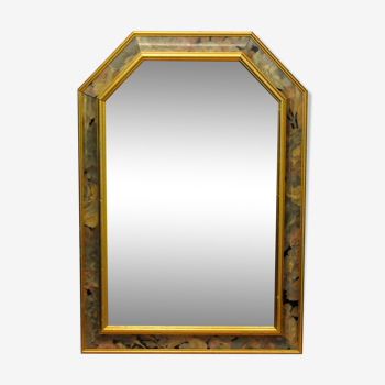 A mirror in a hand-painted frame