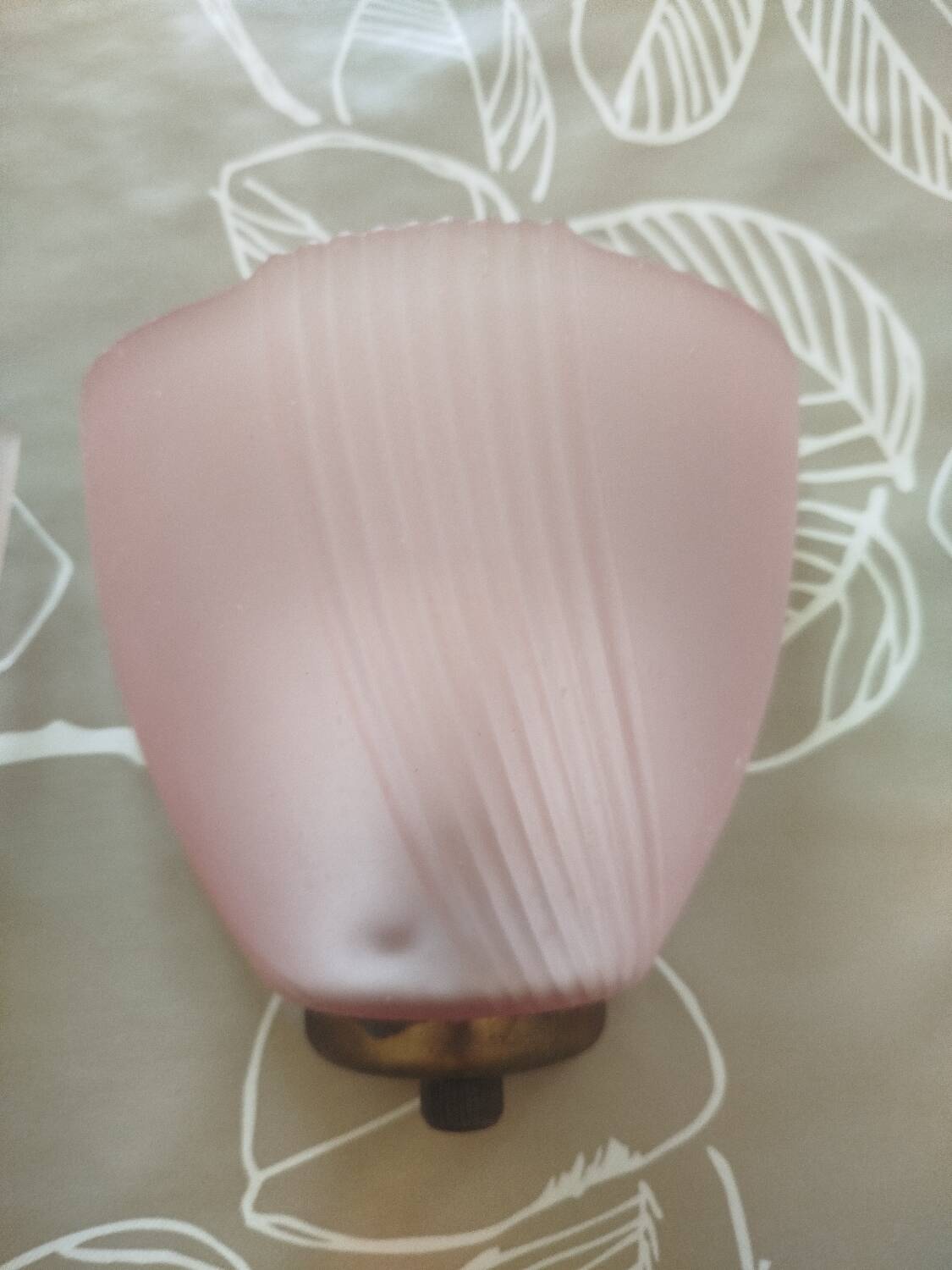 Art Deco wall lights with frosted pink glass and brass.