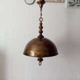 Rustic old wooden and brass suspension.