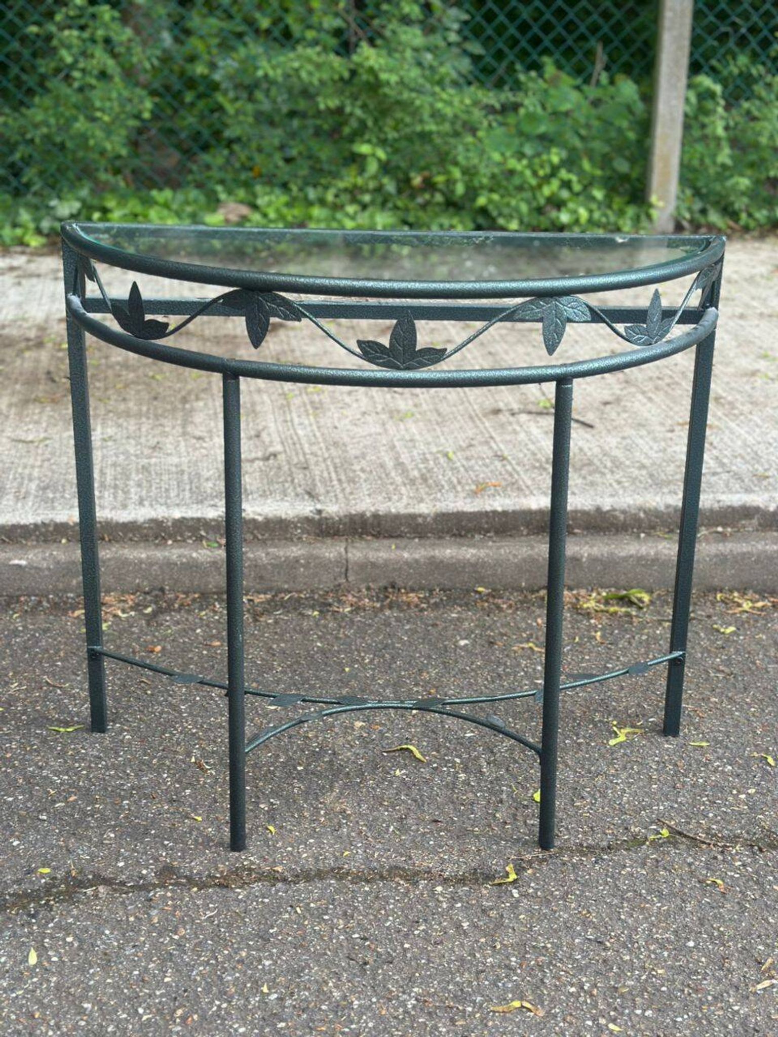 Grey-green wrought iron half-moon console with glass, 85cm.