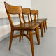 Set of 4 vintage solid oak chairs, 1960s design with sculpted backrest.