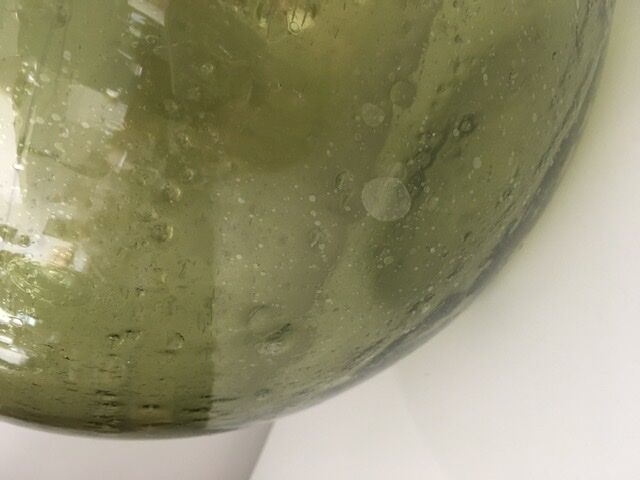 Old demijohn full of bubbles