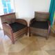 2 colonial-style armchairs in woven rattan and exotic wood