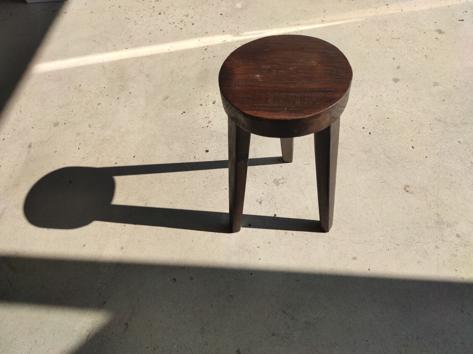 Small high tripod stool in brown solid wood