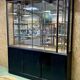 Store window with sliding doors in matte black patinated oak - 30s