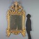 Antique gilded wooden mirror with rococo patterns, Italy, 18th century.