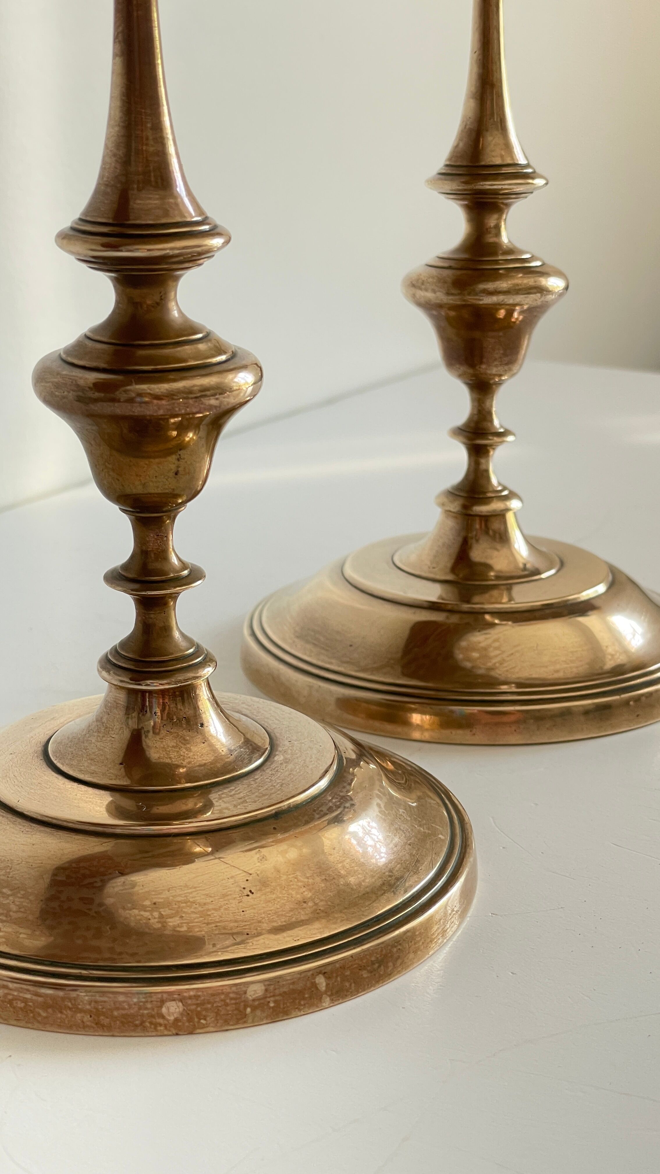 Pair of antique candle holders in solid brass
