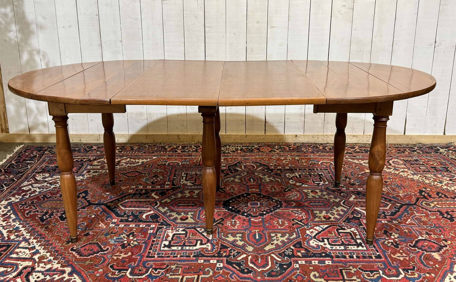Round cherry wood table, 6 feet, Louis Philippe style with 2 extensions.
