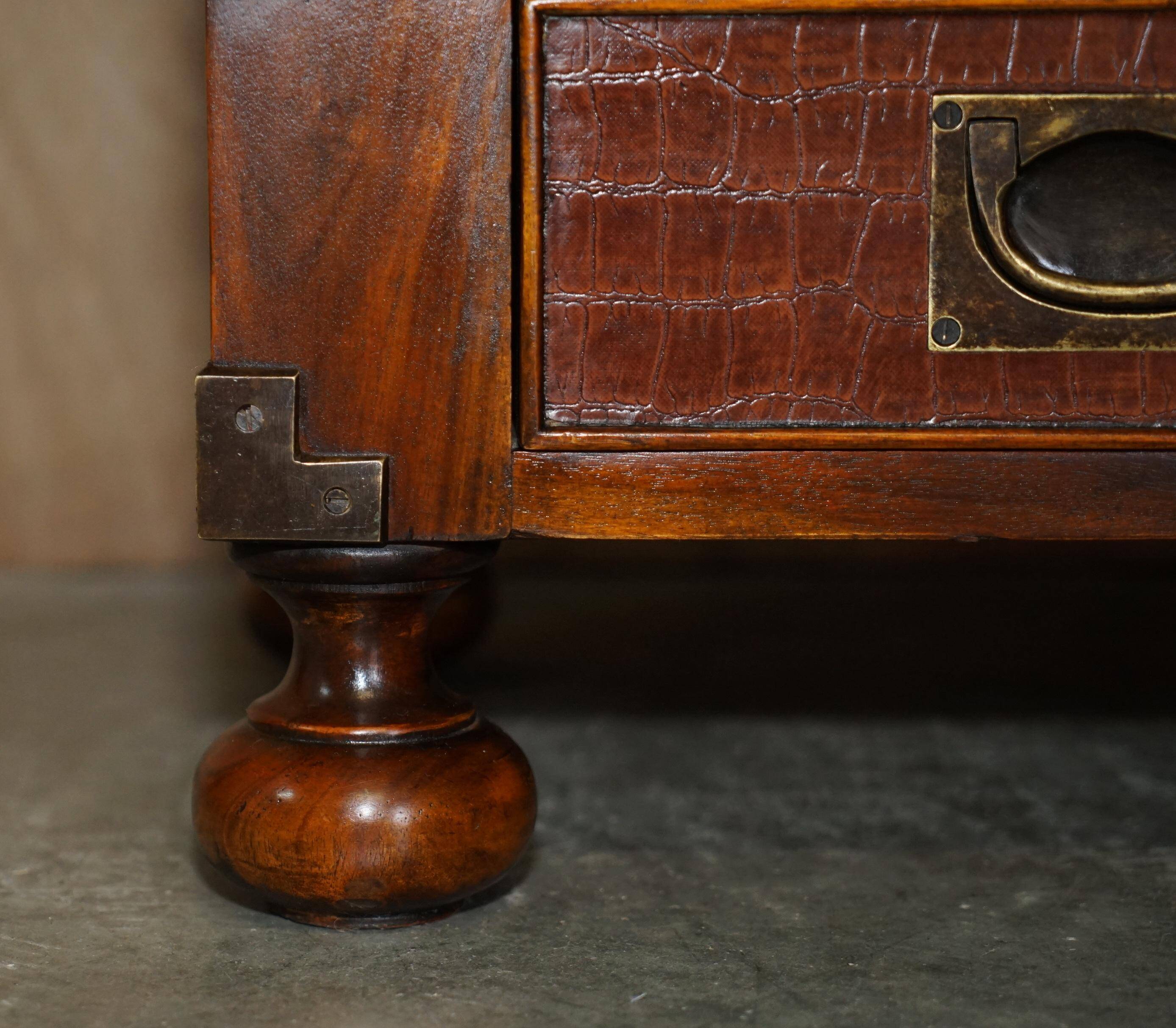 Pair of open bookshelves in crocodile leather with drawers and compartments.