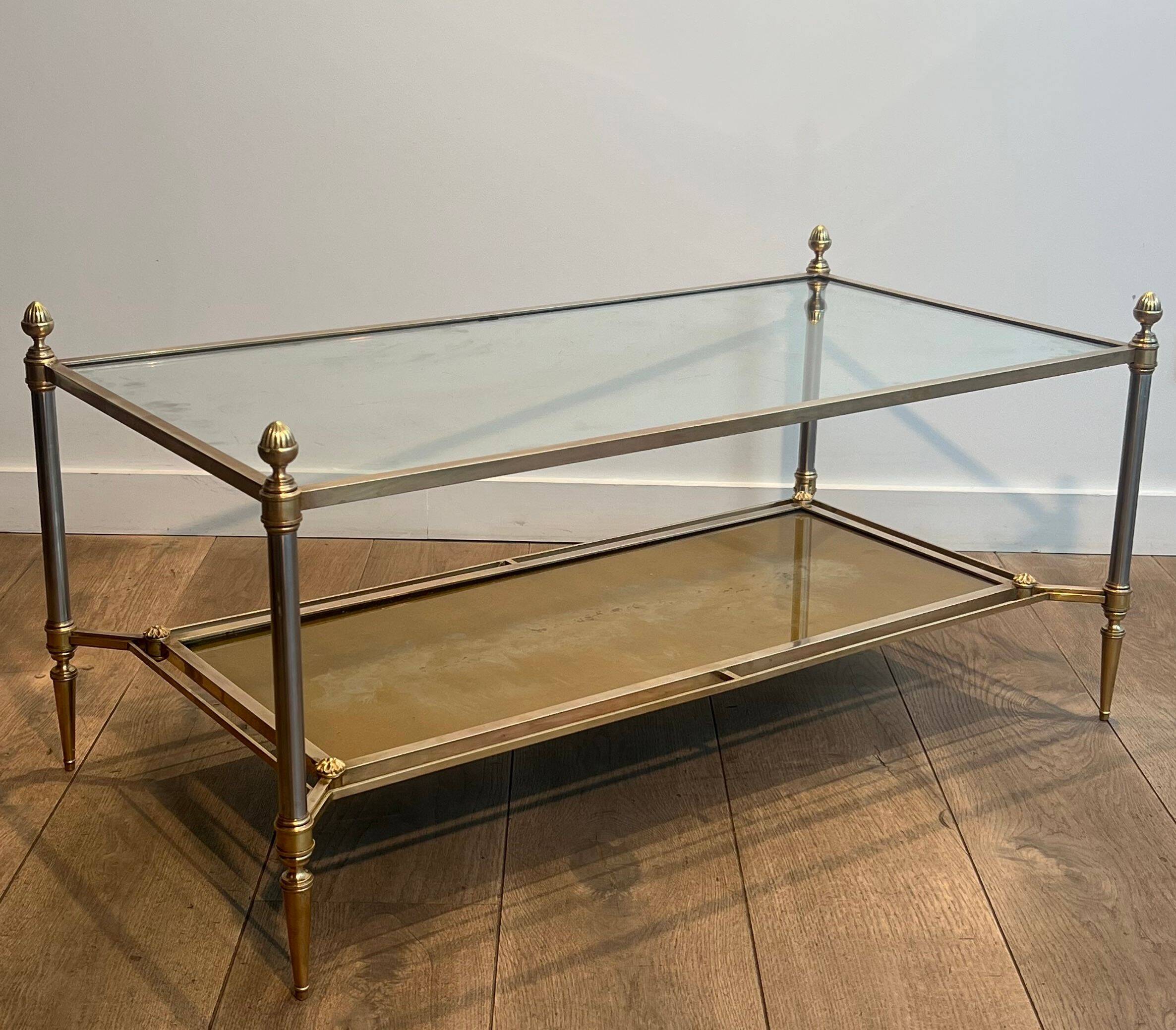 Coffee table in brass, brushed steel, glass, and gilded eglomisé mirror from Maison Jansen.