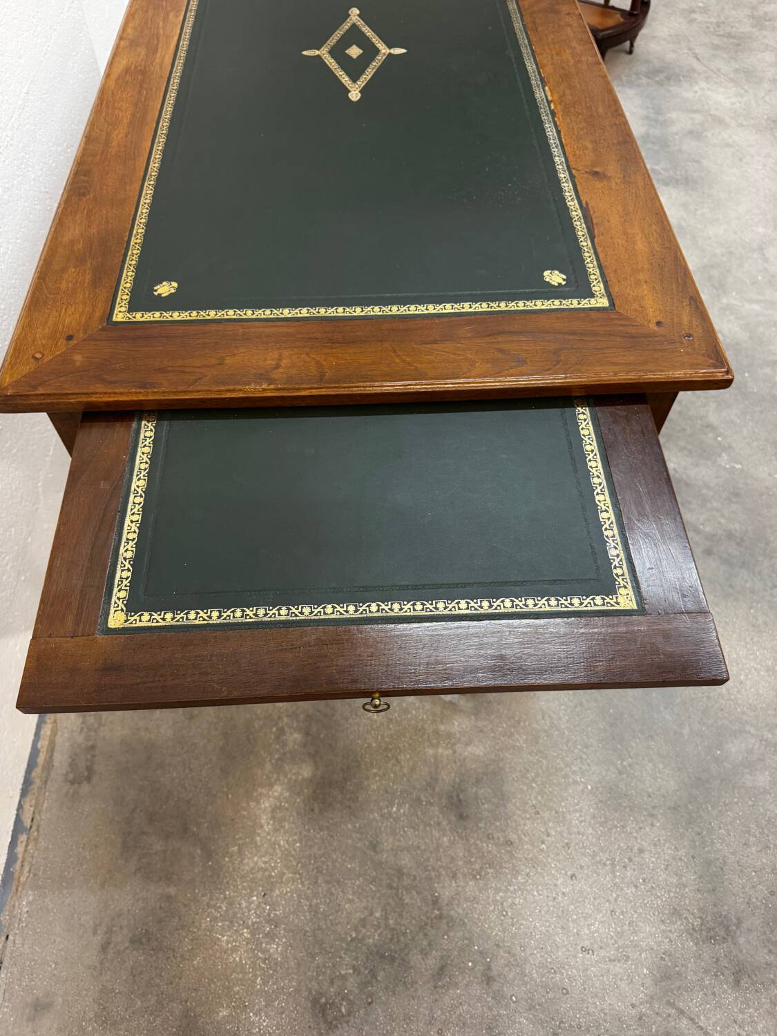 Louis XVI desk with green leather and shelves.