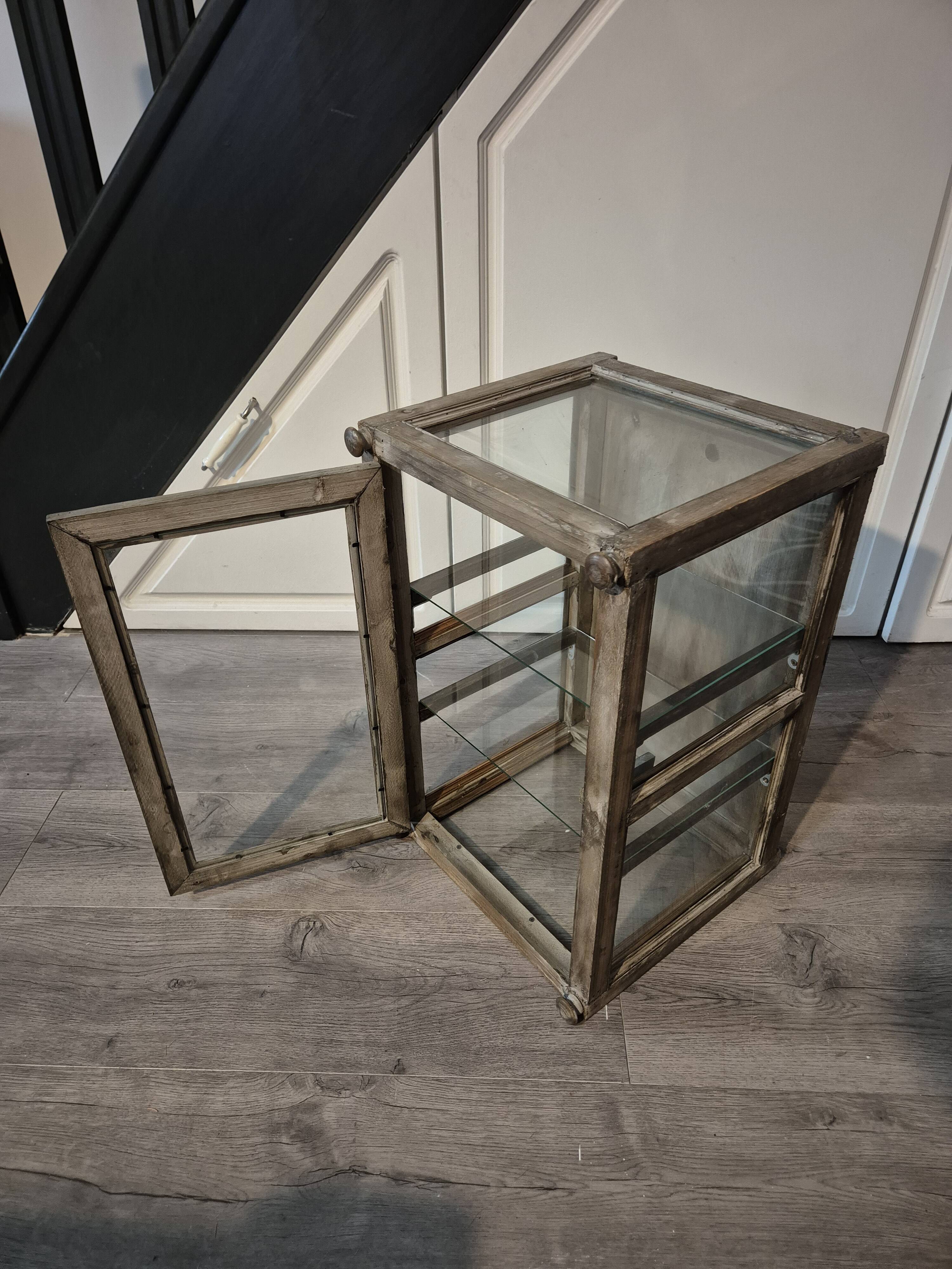 Brown weathered wooden display cabinet with 2 glass shelves.