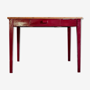 Old wooden workshop table red footing