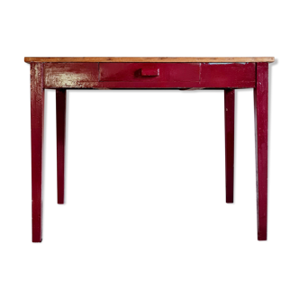 Old wooden workshop table red footing