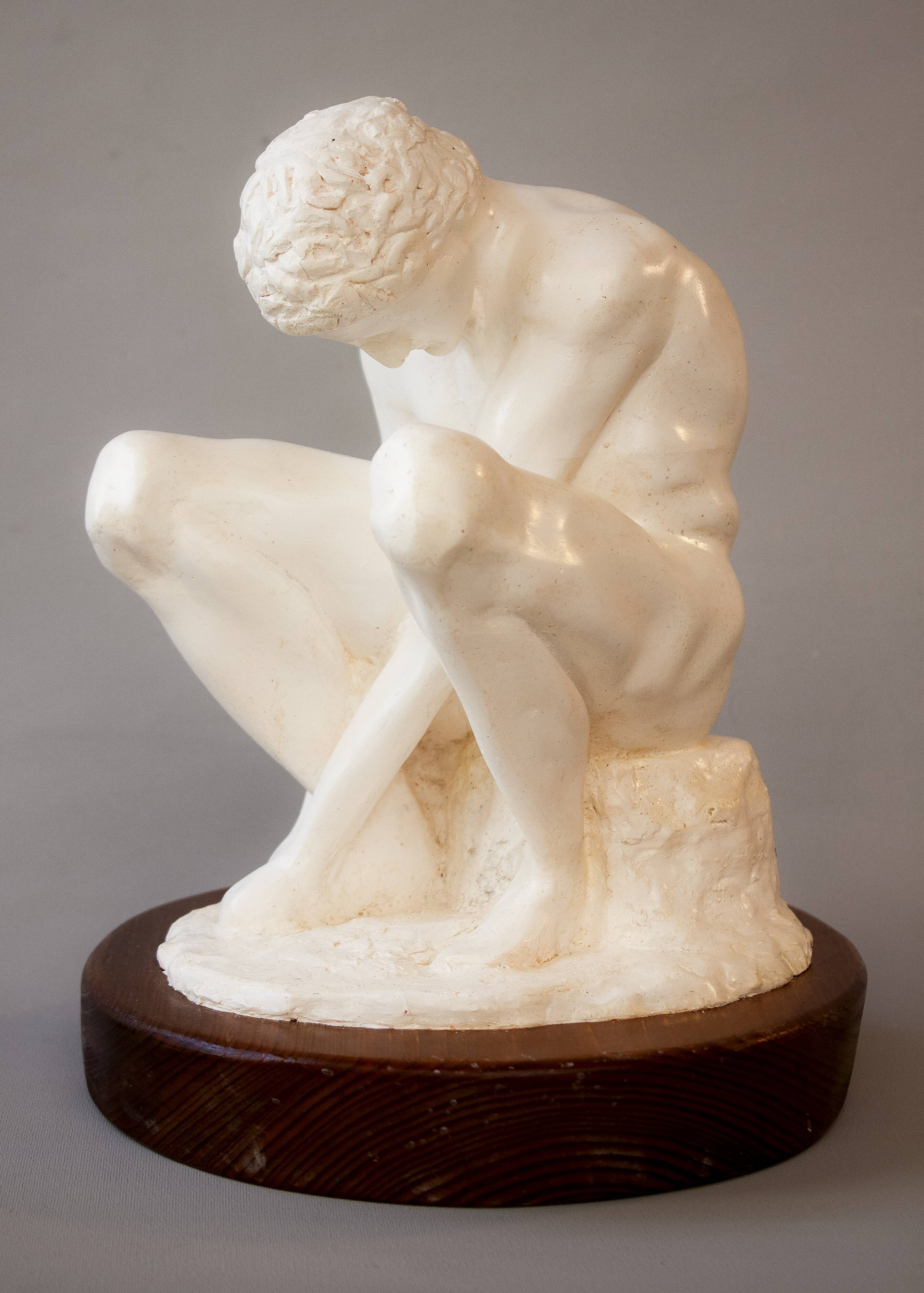 Sculpture of a seated man. Classical male sculpture. Male figure.