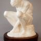 Sculpture of a seated man. Classical male sculpture. Male figure.
