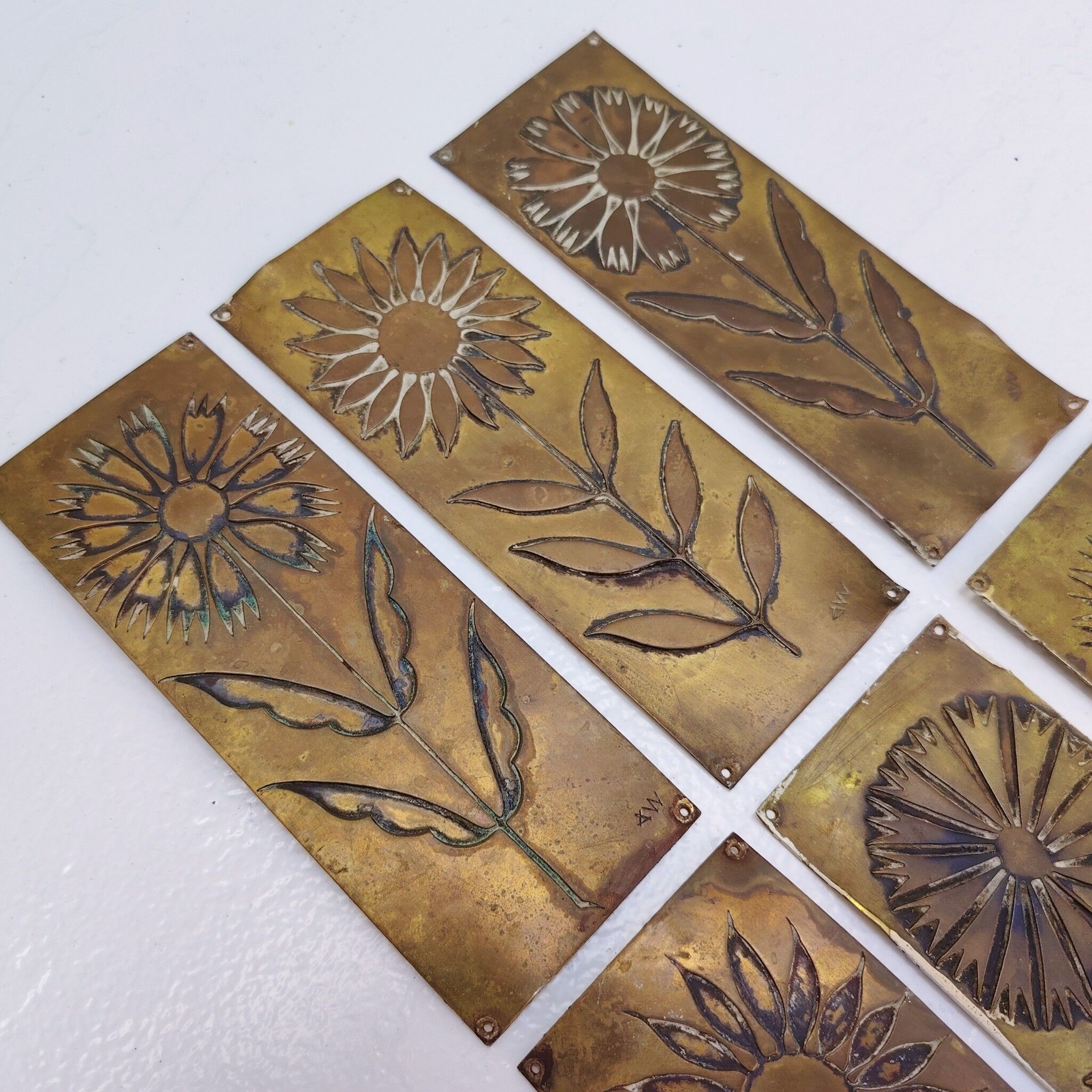 Six cleanliness plaques, flower design, brass.