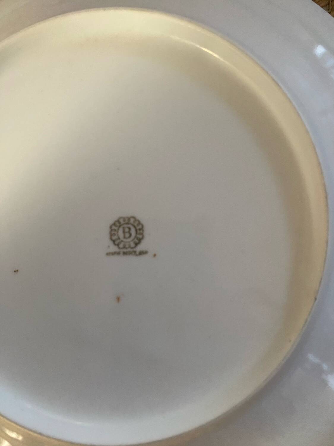 5 mismatched old white plates.