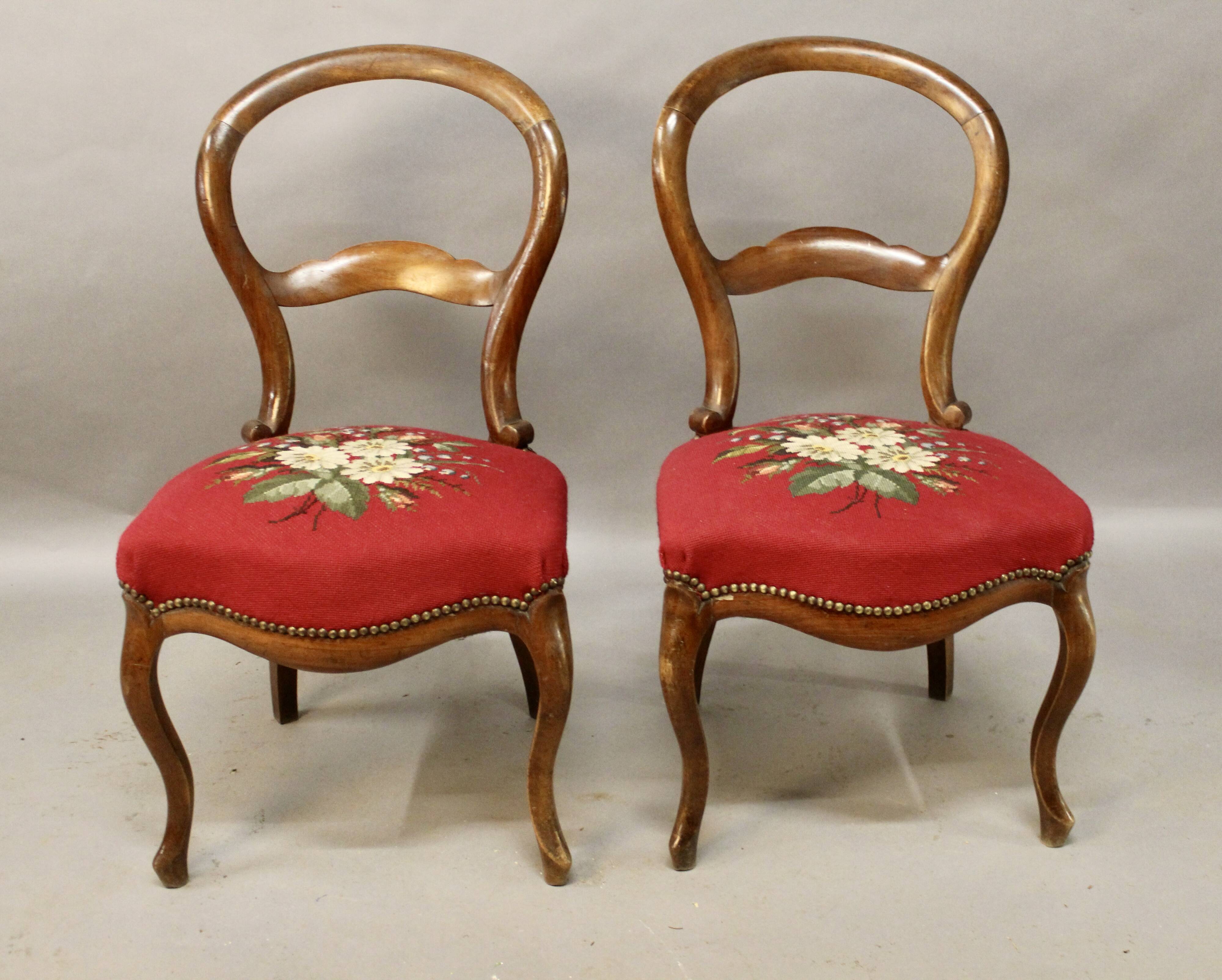 Pair of Louis Philippe walnut chairs, petit point tapestry
