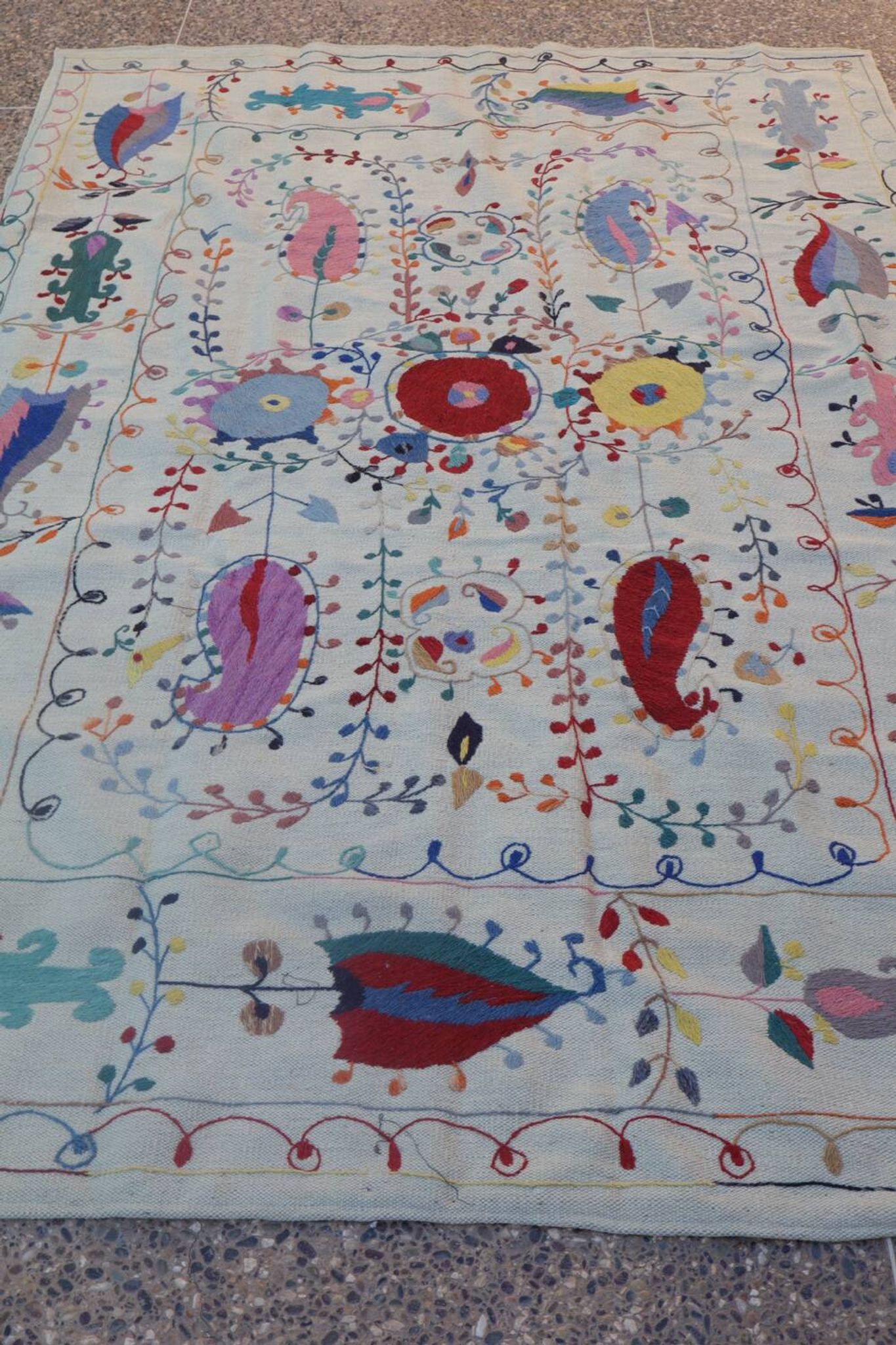 White suzani kilim rug with hand embroidered multi-colored patterns