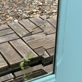 Beveled mirror on turquoise Parisian door