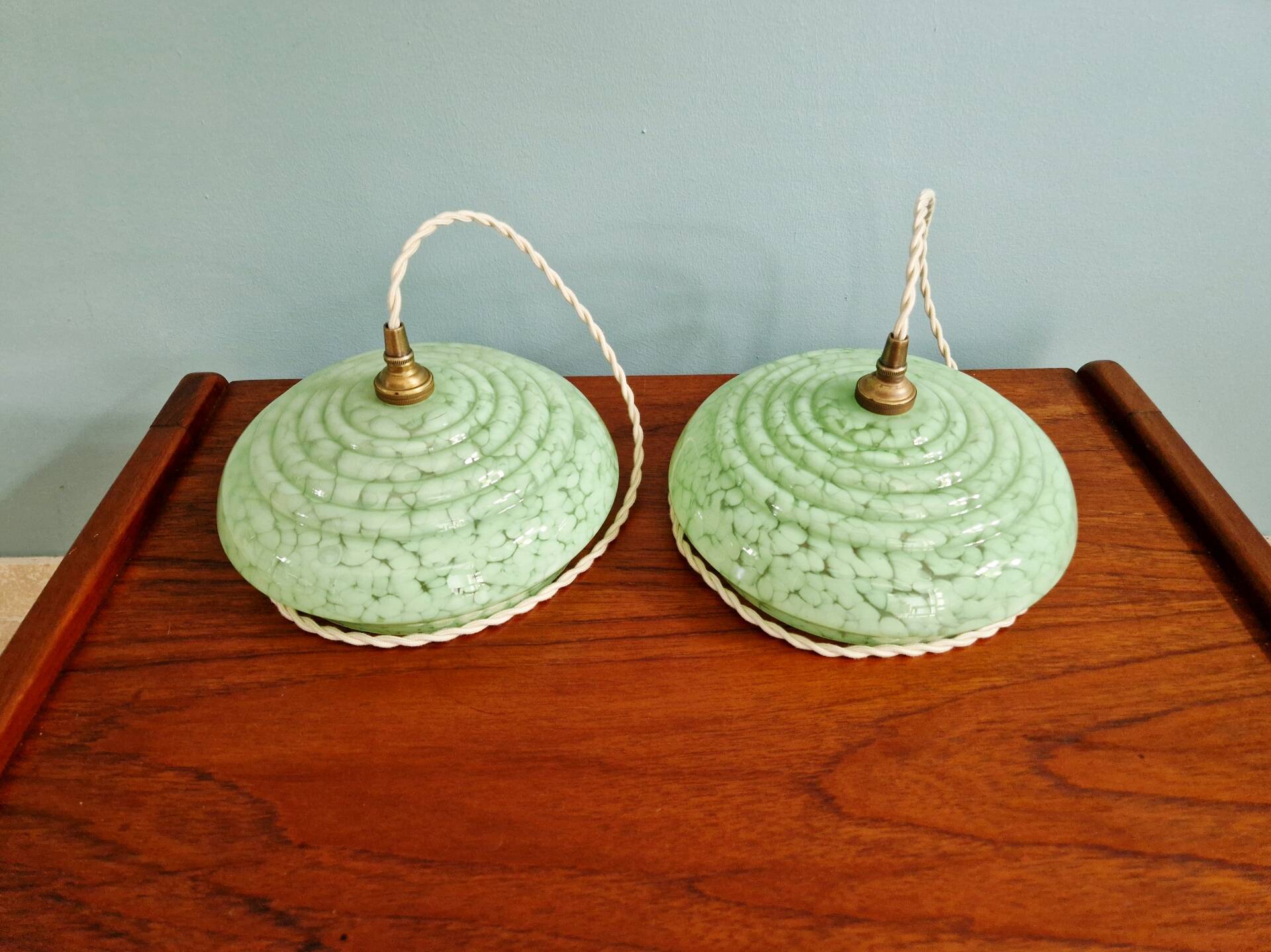 Pair of Art Deco light fixtures in light green speckled glass, 1930s.