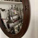 Antique oval mirror in carved wood and Louis XVI style knot