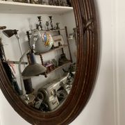 Antique oval mirror in carved wood and Louis XVI style knot