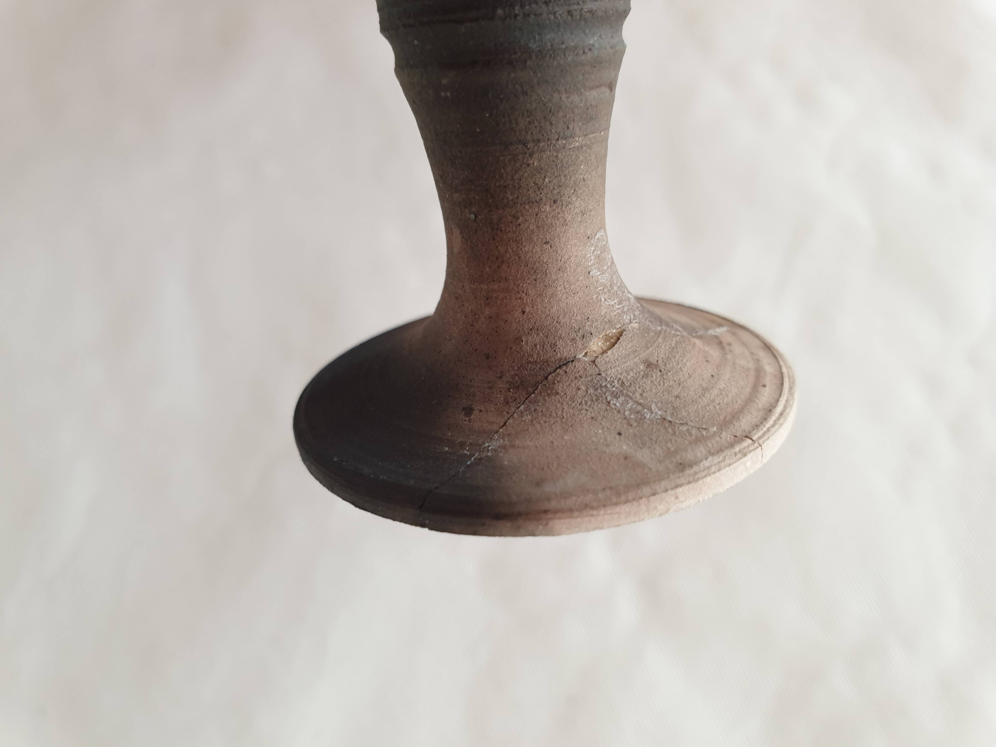 Green pot-bellied ceramic vase with foot and high, narrow neck in signed raku