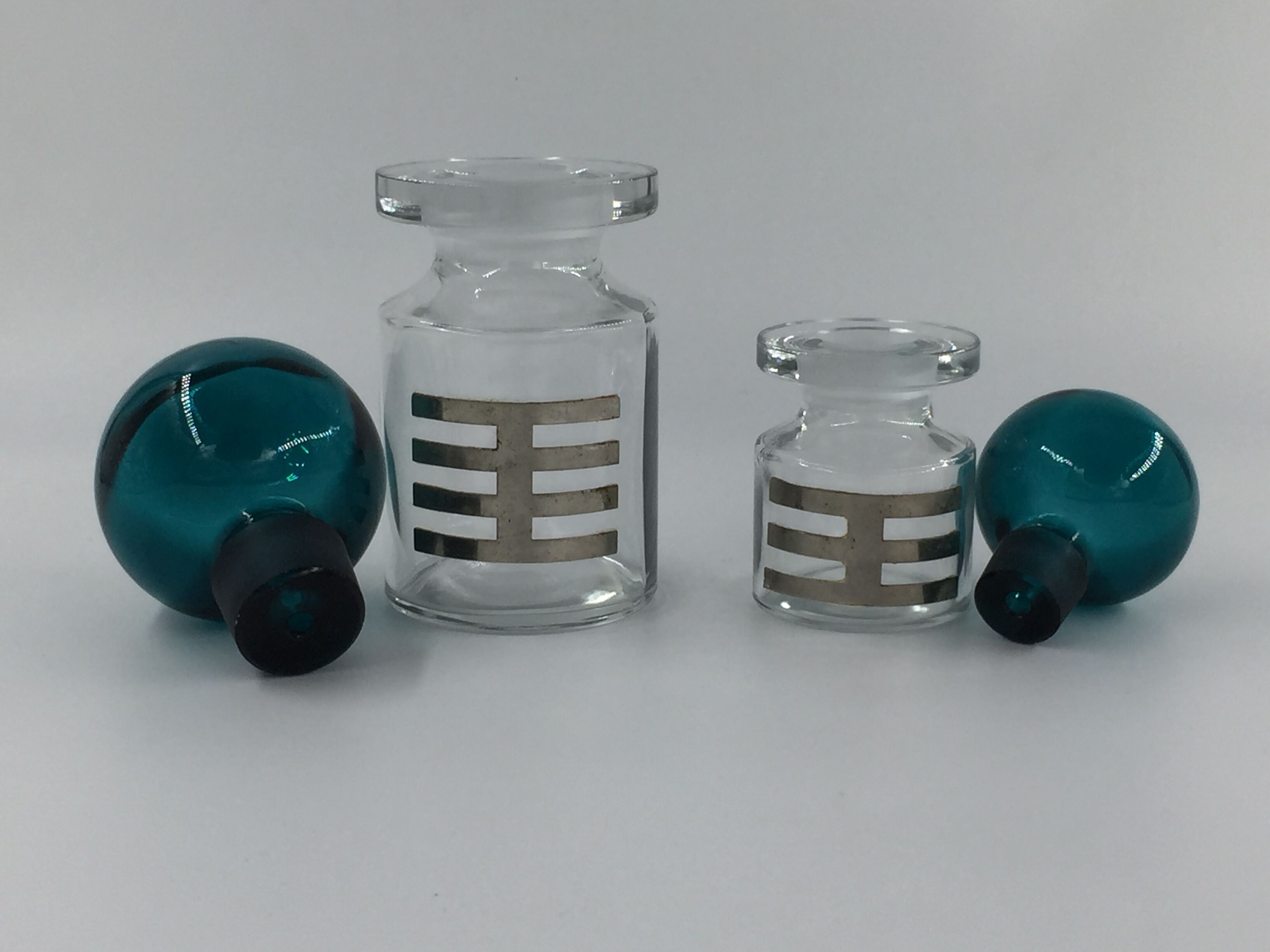 Two vintage 70s glass and metal bottles