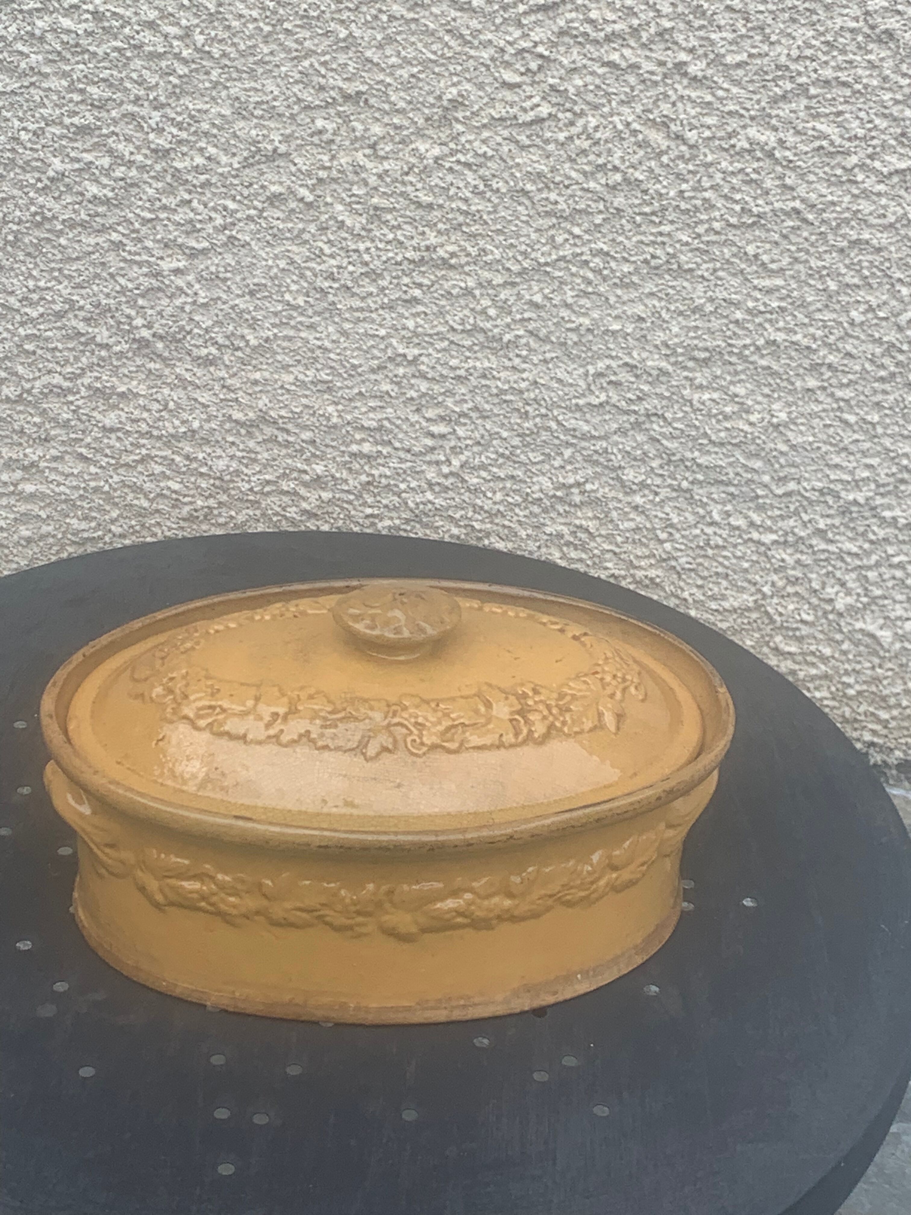 Old terrine in glazed stoneware and floral decoration mustard yellow slip