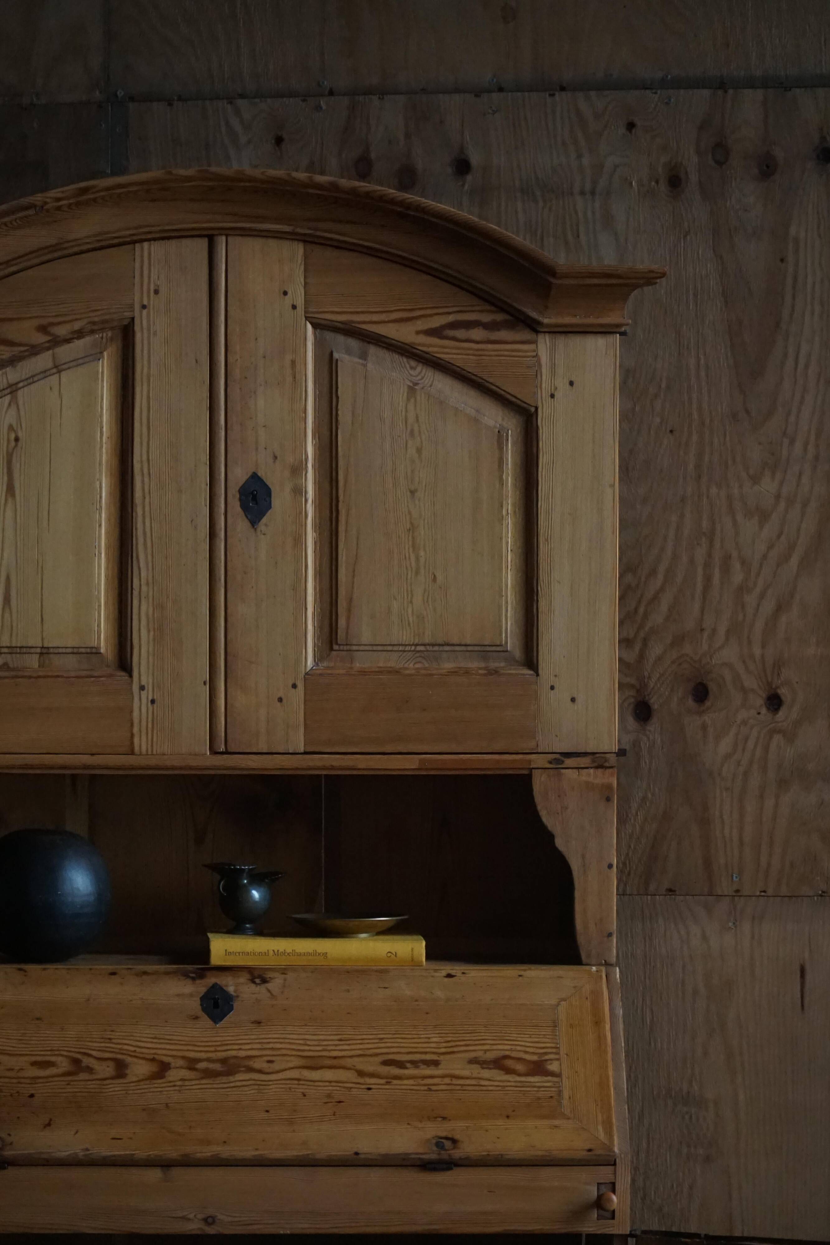 Old Danish secretary in pine with drop-down front and upper cabinet, mid-19th century.