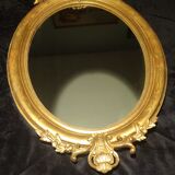 Ovoid mirror with double pediments gilded with leaf circa 1830, 105x66 cm