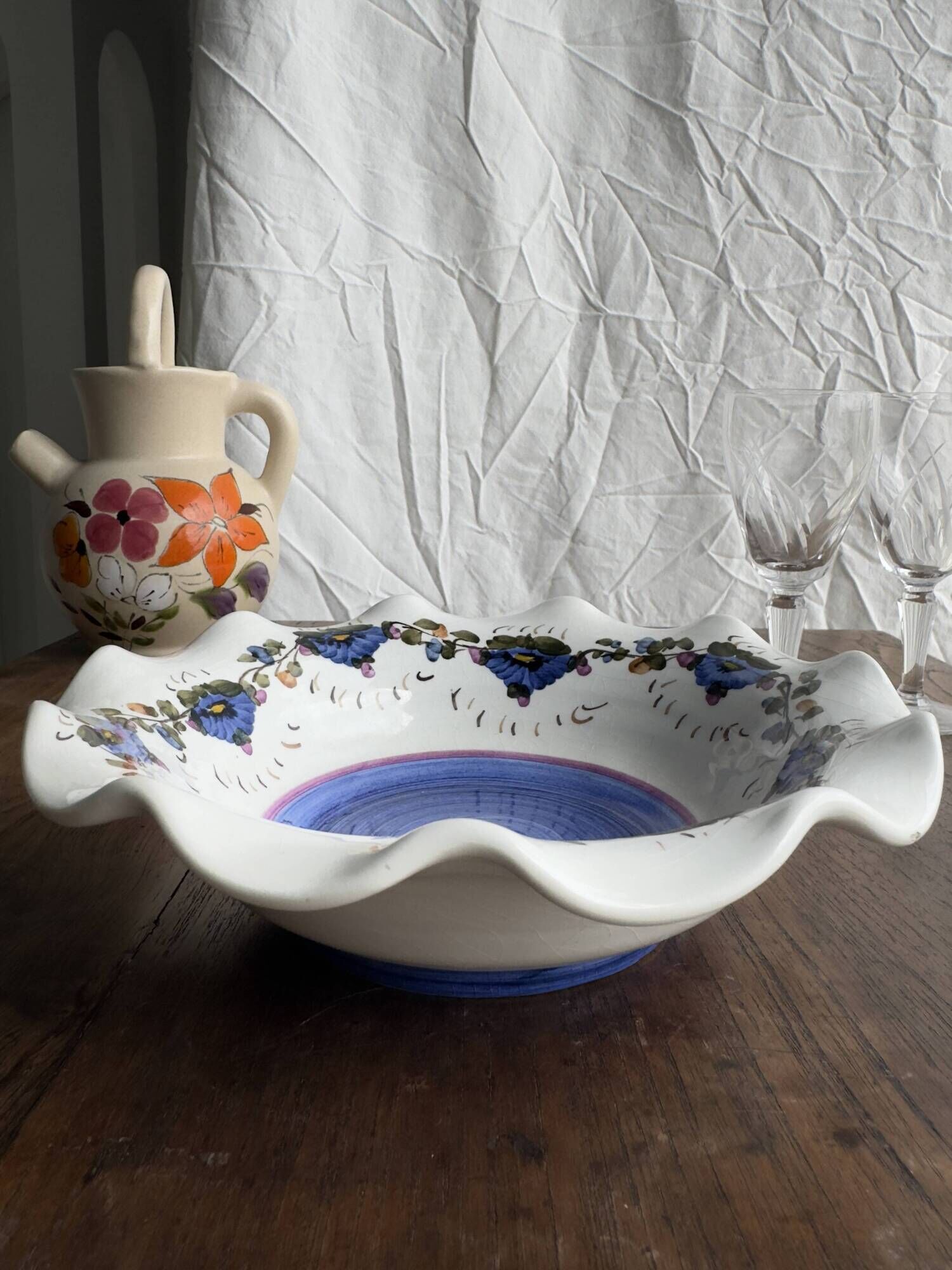 Small hand-painted earthenware salad bowl with garland of blue flowers, mark below