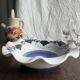 Small hand-painted earthenware salad bowl with garland of blue flowers, mark below
