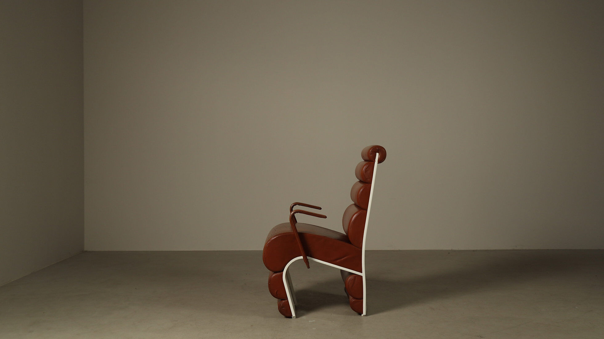 Pair of sculptural cognac leather armchairs, 1970s
