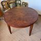 Oval extendable dining table in wood and walnut burl veneer.