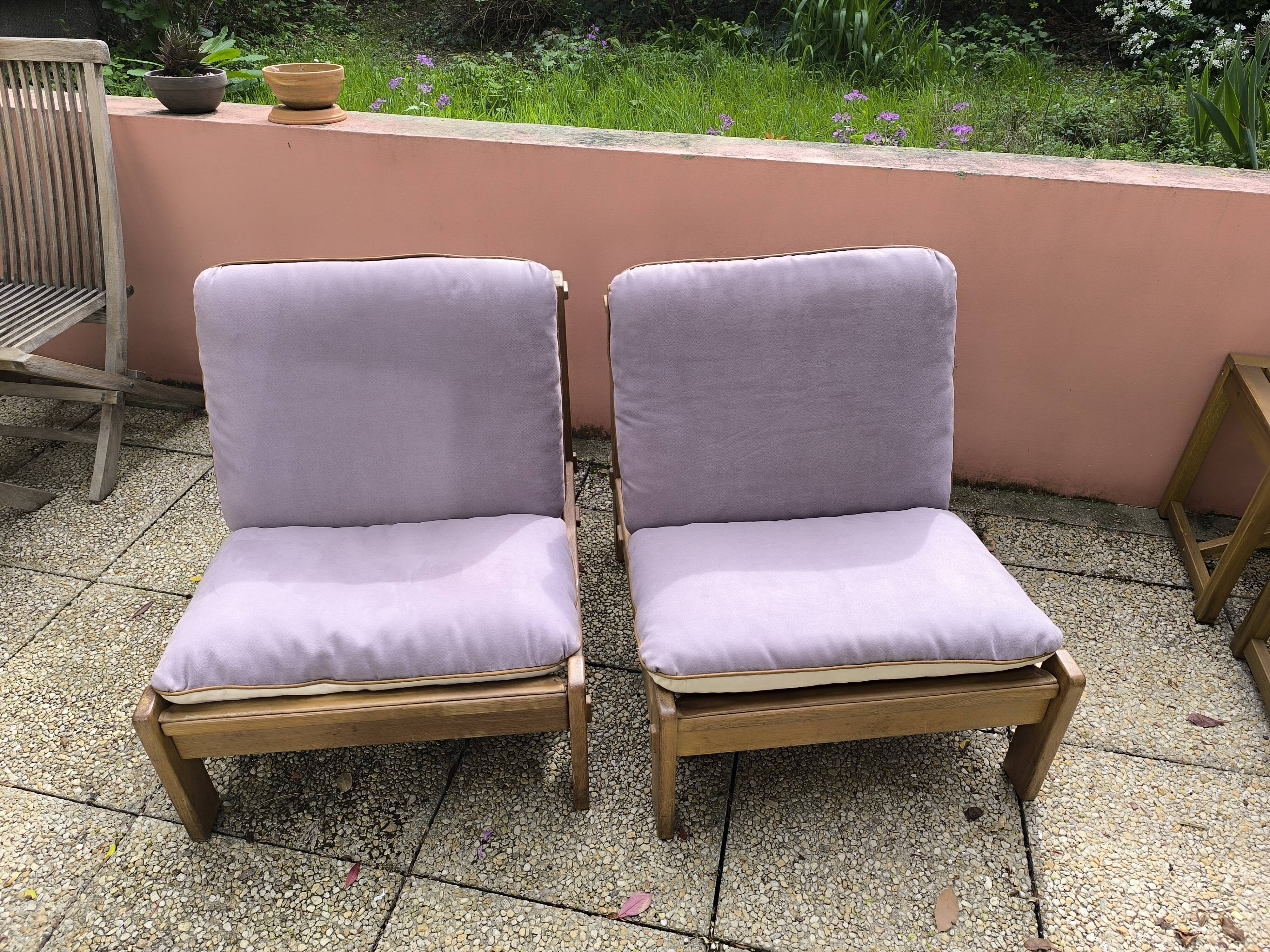 Pair of solid wood and leather lounge chairs, European work, circa 1970.
