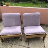 Pair of solid wood and leather lounge chairs, European work, circa 1970.