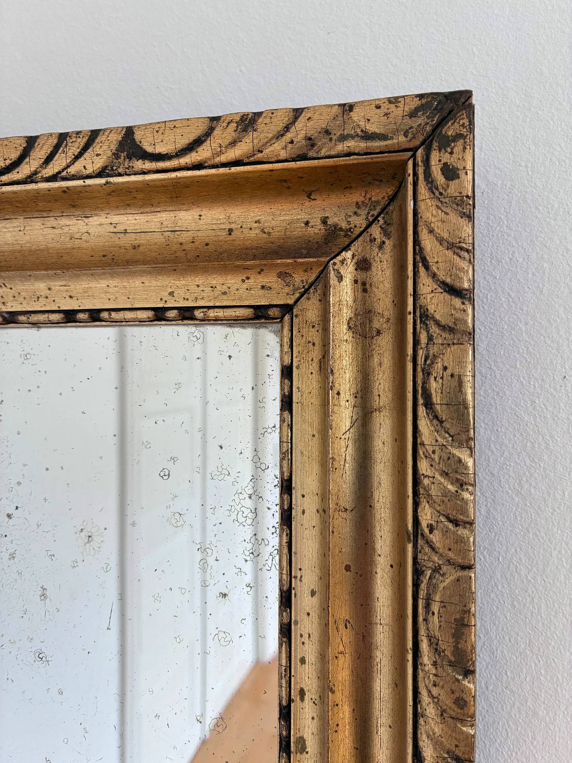 Antique French giltwood wall mirror in gold