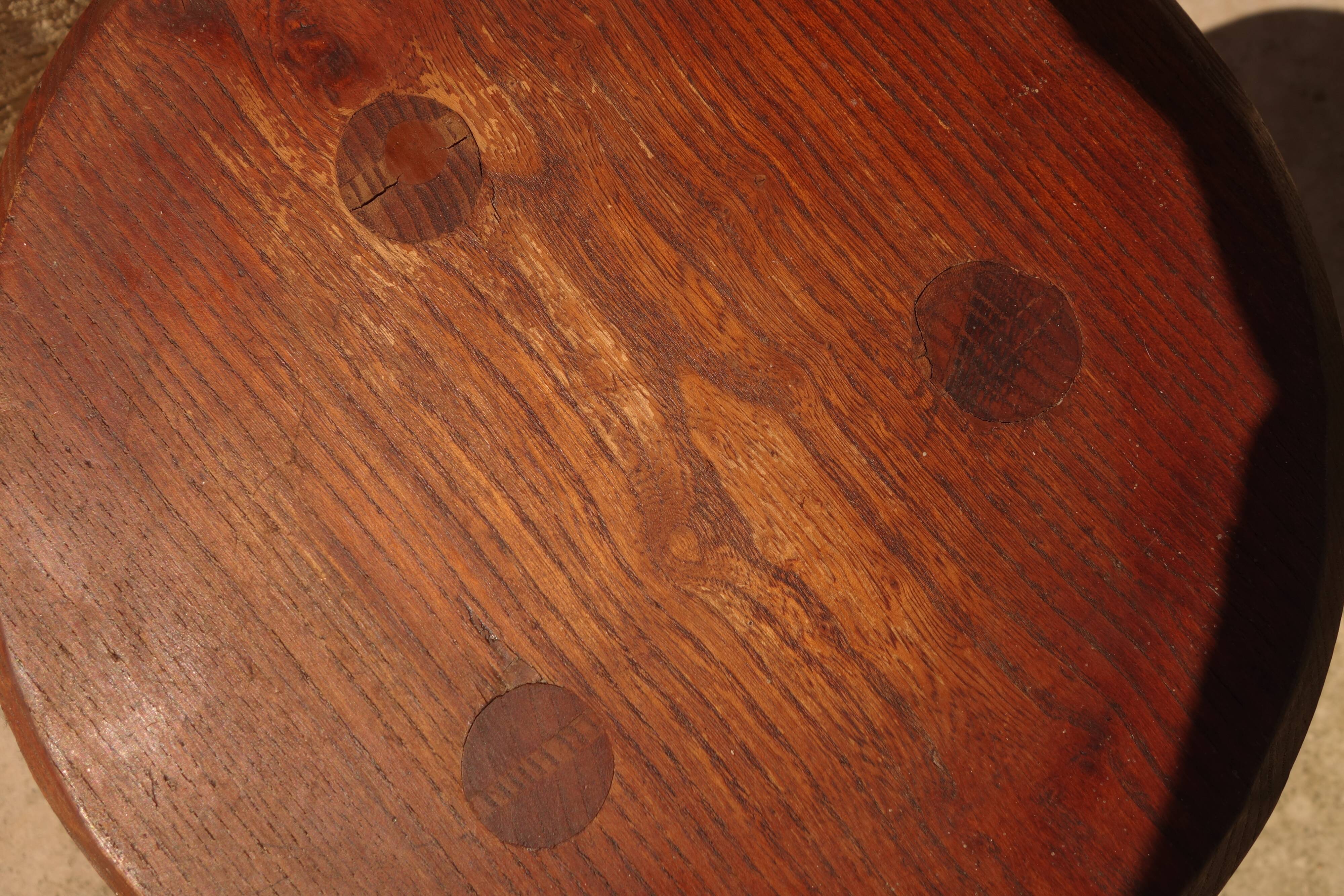 Brutalist tripod stool from the 50s in wood.