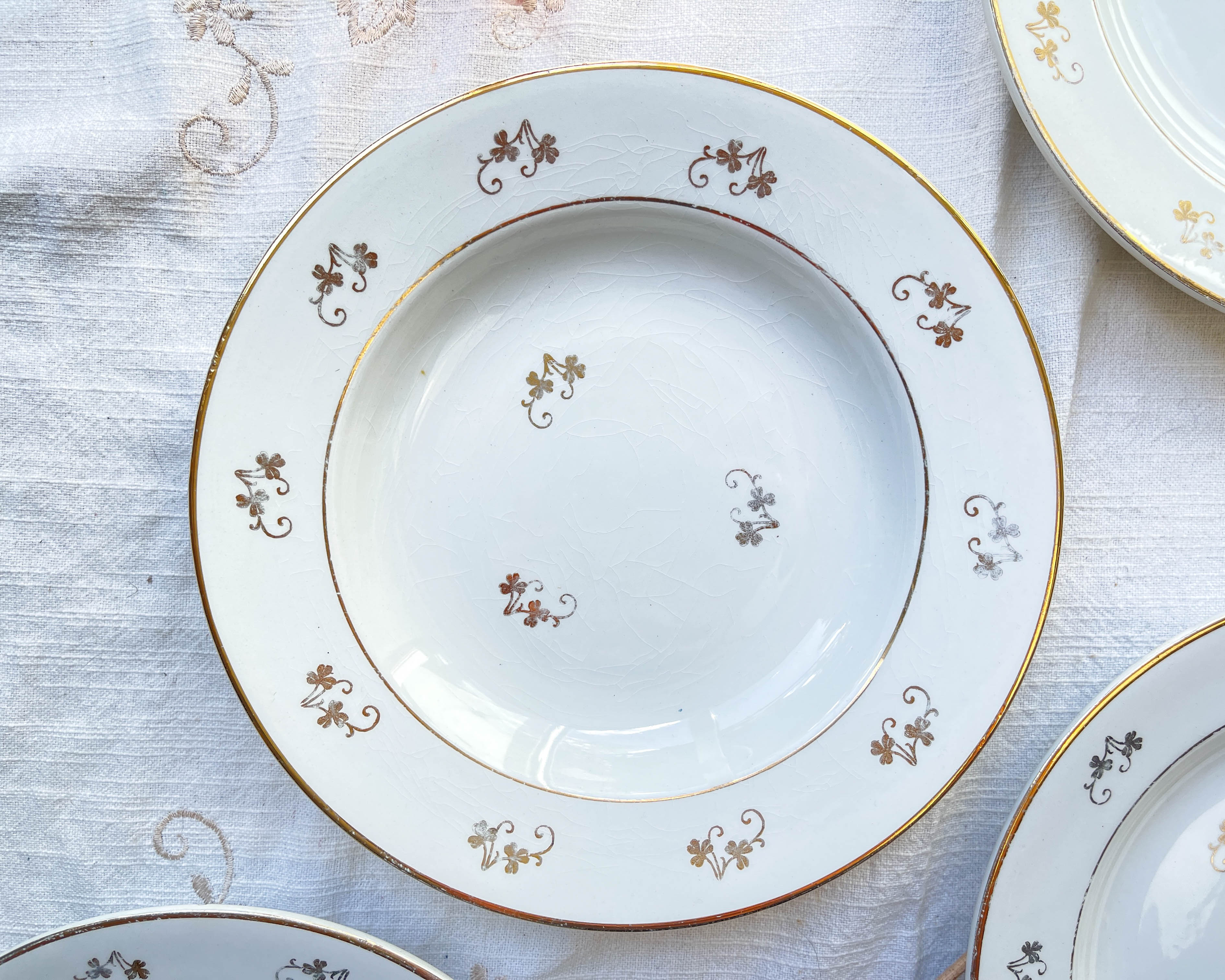 4 white porcelain L'Amandinoise soup plates with gold floral pattern