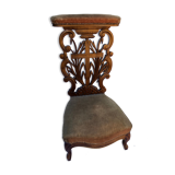 Low armchair in carved wood